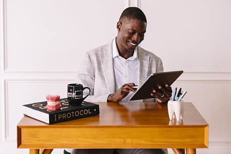 Dr. Femi Fadahunsi reviewing a treatment plan on a tablet